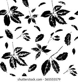 Black and white seamless pattern with leaves of wild grape and maple seeds stylized as stamp or imprint; rustic or boho style. May be used for textile, wrapping paper or in scrapbooking