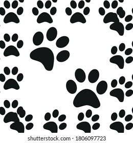 Black and white seamless pattern with paw prints. Abstract background, animal footprint