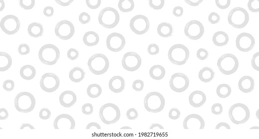 Black and white seamless pattern with rings in brush stroke technique. Vector abstract background with random hand painted circles.