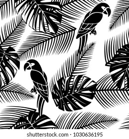 Black and white seamless tropical pattern with leaves and parrots.