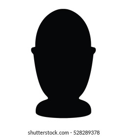 A black and white silhouette of an egg and an eggcup