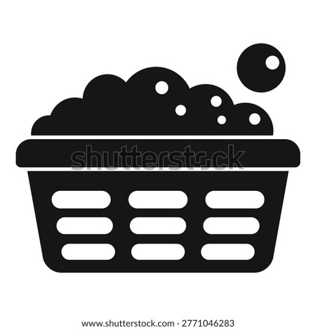 Black and white silhouette of a plastic laundry basket full of clothes, water, soap, and suds