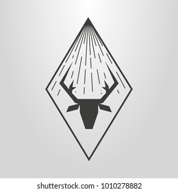 black and white simple vector symbol of deer head with light beams in a rhombus frame