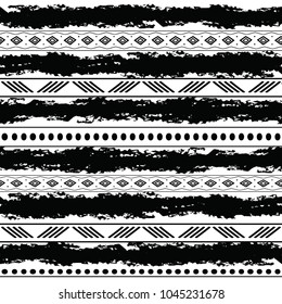 Black and white tribal vector seamless pattern with doodle elements. Aztec abstract geometric art print. Ethnic ornamental hand drawn backdrop.