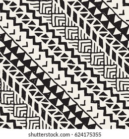 Black and white tribal vector seamless pattern with doodle elements. Aztec abstract geometric art print. Ethnic ornamental hand drawn backdrop.