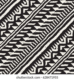 Black and white tribal vector seamless pattern with doodle elements. Aztec abstract geometric art print. Ethnic ornamental hand drawn backdrop.