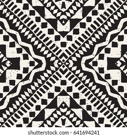 Black and white tribal vector seamless pattern with doodle elements. Aztec abstract geometric art print. Ethnic ornamental hand drawn backdrop.