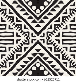 Black and white tribal vector seamless pattern with doodle elements. Aztec abstract geometric art print. Ethnic ornamental hand drawn backdrop.