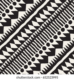 Black and white tribal vector seamless pattern with doodle elements. Aztec abstract geometric art print. Ethnic ornamental hand drawn backdrop.