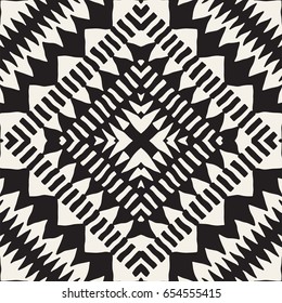 Black and white tribal vector seamless pattern with doodle elements. Aztec abstract geometric art print. Ethnic ornamental hand drawn backdrop.