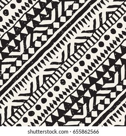 Black and white tribal vector seamless pattern with doodle elements. Aztec abstract geometric art print. Ethnic ornamental hand drawn backdrop.