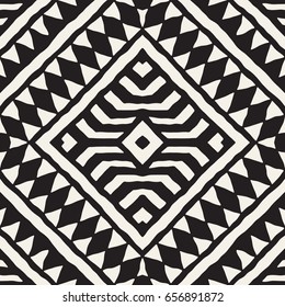 Black and white tribal vector seamless pattern with doodle elements. Aztec abstract geometric art print. Ethnic ornamental hand drawn backdrop.