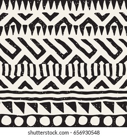 Black and white tribal vector seamless pattern with doodle elements. Aztec abstract geometric art print. Ethnic ornamental hand drawn backdrop.