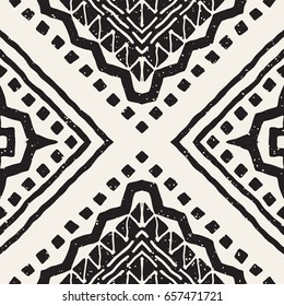 Black and white tribal vector seamless pattern with doodle elements. Aztec abstract geometric art print. Ethnic ornamental hand drawn backdrop.
