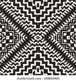 Black and white tribal vector seamless pattern with doodle elements. Aztec abstract geometric art print. Ethnic ornamental hand drawn backdrop.