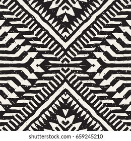 Black and white tribal vector seamless pattern with doodle elements. Aztec abstract geometric art print. Ethnic ornamental hand drawn backdrop.
