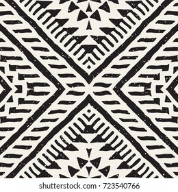 Black and white tribal vector seamless pattern with doodle elements. Aztec abstract geometric art print. Ethnic ornamental hand drawn backdrop.