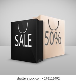 Black and white two shopping bags with written sale, isolated on white
