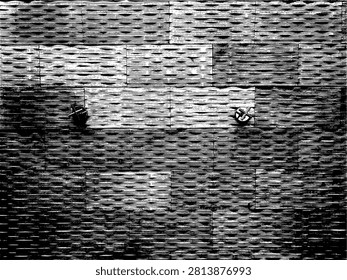 Black and white vector illustration of two water faucets on a textured brick wall. High contrast graphic stencil silhouette texture for commercial screen printing and industrial streetwear design.