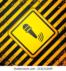 Black Wireless microphone icon isolated on yellow background. On air radio mic microphone. Speaker sign. Warning sign. Vector