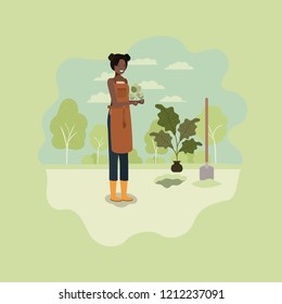 black woman planting tree in the park