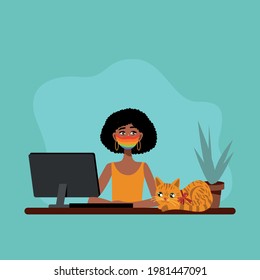 Black woman works at the computer with cat. Black woman in a mask.