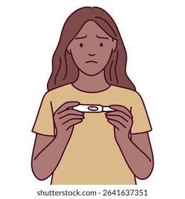 Black woman in yellow shirt looks sad while holding negative pregnancy test. Shows disappointment, stress, and emotional reaction