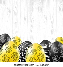 Black and yellow eggs with pattern on wood background. Happy easter card template. Vector illustration.