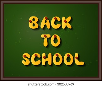 Blackboard with Back to school title from yellow letters and pins.