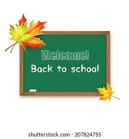 Blackboard decorated with autumn maple leaves isolated on white background