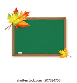 Blackboard decorated with autumn maple leaves isolated on white background