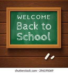 Blackboard with text "back to school" on wooden wall