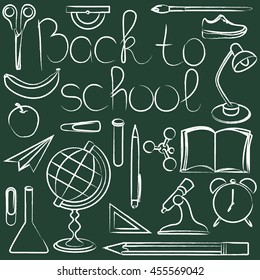 blackboard with the words back to school, and school supplies