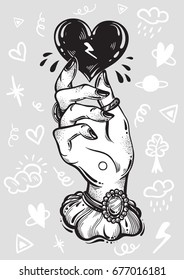 Blackwork tattoo flash. Vintage woman`s hand holding black heart. Doodle signs around. Dark romance. High-detailed vector artwork isolated. Tattoo art, mystic symbol, alchemy. Print, poster, t-shirts.