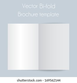 Blank bi fold paper brochure on light background with soft shadows and highlights. 