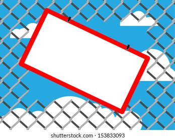 Blank board on chain link fence with copy space on blue sky background