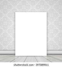 Lienzo en blanco sobre el suelo inclinado contra una pared con un patrón de papel tapiz Damask