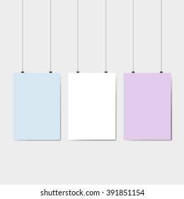 Blank color pages hanging against grey background