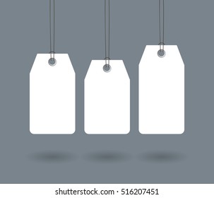 Blank dangling paper label or cloth tag set isolated on dark gray background. Sale tags for promo design and advertising