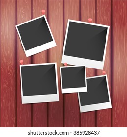 Blank instant photo frames pinned to wooden vector background