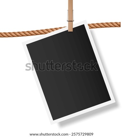 Blank instant photo with white frame hanging on brown rope with wooden clothespin, isolated on white background, creating vintage memories concept