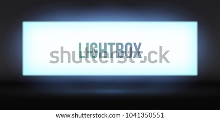 Blank lightbox in the dark. Illuminated lightbox screen with empty space for design. Blank billboard or white LCD display screen.