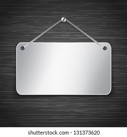 Blank metallic tablet hanging on dark brushed metallic wall. Vector illustration