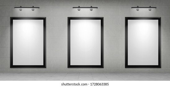 Blank movie posters illuminated by spotlights. Vector realistic mockup of white picture in black frames on gray tiled wall in cinema, theater hallway or gallery. Empty advertising banners with lamps