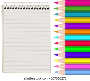 blank notebook and a set of colored pencils
