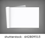 Blank open magazine with rolled page on neutral grey background . Horizontal orientation. Template for your design.