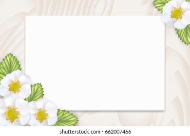 Blank paper with empty tag for your text and cute white strawberry flowers and leaves on wooden table, top view. Can be used as mockup