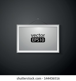 blank paper frame on black wall
