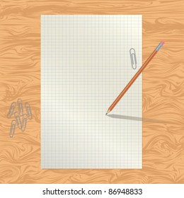 blank paper on the table with a pencil and paper clips