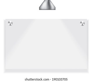 Blank paper on white wall. The lamp is shinig on it